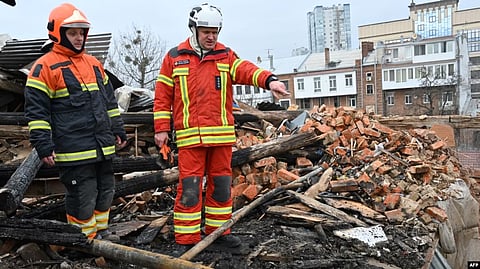 Ukrainian rescuers access at the debris for clearing at a residential building, partially destroyed after a missile strike on Kharkiv on Jan. 30, 2023. (AFP)