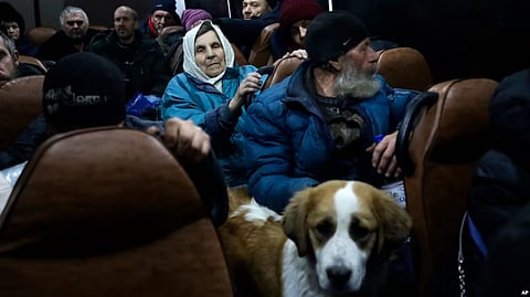 People from Soledar sit inside a bus as they wait to be registered and take up temporary accommodation somewhere near Shakhtarsk, in Russian-controlled Donetsk region, eastern Ukraine, Jan. 13, 2023. (AP)