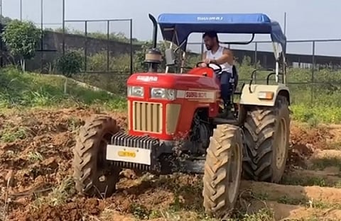 Former captain of the Indian cricket team MS Dhoni drove a tractor in his fields. (IANS)