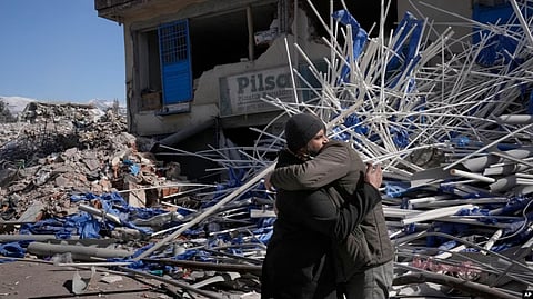 Syrian men comfort each other, in Kahramanmaras city, southern Turkey, Feb. 15, 2023. (AP)