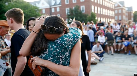 FILE - People hug as they gather for a vigil in response to a fatal shooting in the Capital Gazette newsroom, June 29, 2018, in Annapolis, Maryland. Journalists, who report on tragedy daily, experience trauma at rates comparable to first responders, according to a recent study. (AP)