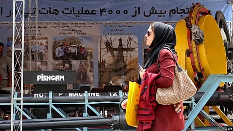 FILE - A visitor walks past a displayed machine during the 24th International Oil, Gas, Refining & Petrochemical Exhibition at Tehran Permanent Fairground in Tehran, May 1, 2019. (AFP)