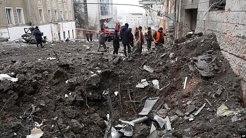 Emergency and municipal workers clear the rubble from a residential building which was hit by a Russian rocket, in the city center of Kharkiv, Feb. 5, 2023. (AP)