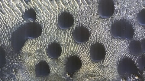While sand dunes of many shapes and sizes are common on Mars. The MRO captured "dunes that are almost perfectly circular, which is unusual," wrote planetary geologist Alfred McEwen for a HiRise picture-of-the-day feature.(File Photo/IANS)