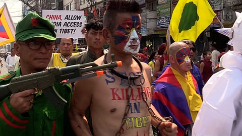 Tibetans march on the anniversary of the 1959 uprising against China