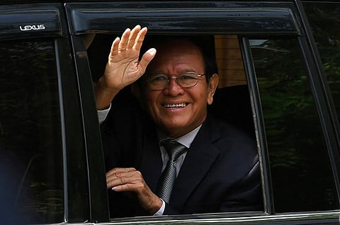 Kem Sokha, former leader of the now-dissolved Cambodia National Rescue Party (CNRP), greets people as he leaves the Phnom Penh Municipal Court after attending his treason trial in Phnom Penh, Oct. 19, 2022. (AFP)