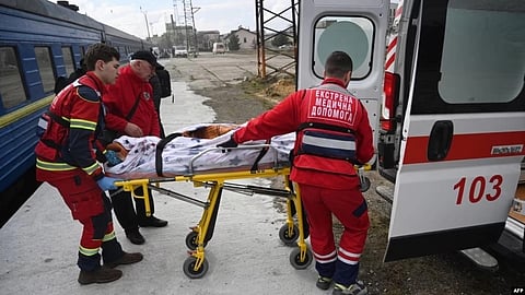Medical workers transfer a wounded civilian patient from a train to an ambulance upon his arrival from the east of Ukraine in the western Ukrainian city of Lviv.