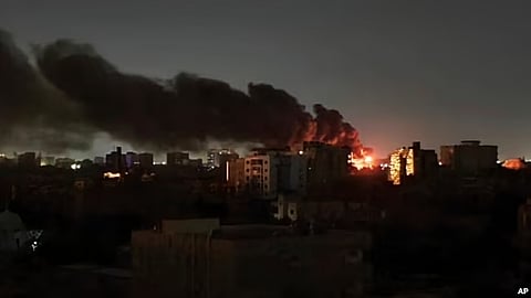 Smoke rises over the horizon as a fire burns after a strike in Khartoum, Sudan.