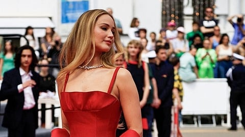 Actress Jennifer Lawrence turned heads in a cherry red, crepe silk gown by Dior Haute Couture which featured spaghetti straps and a soft ruffle at the bustline along with a matching red wrap. (IANS)
