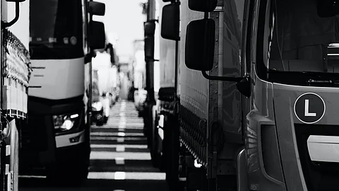 Trucks have a large turn radius. They often have to enter an adjacent lane to make a turn, especially a left turn, to avoid hitting a curb, sidewalk, or another motor vehicle. (Unsplash)