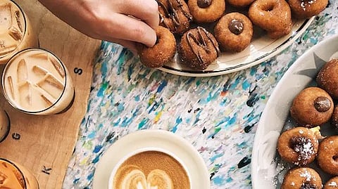 As the season ushers in its own charm, coffee and donut shops have started buzzing. We've handpicked a list of the city's most enchanting coffee and donut cafes, each offering a unique experience that's perfect for this time of the year. (Unsplash)