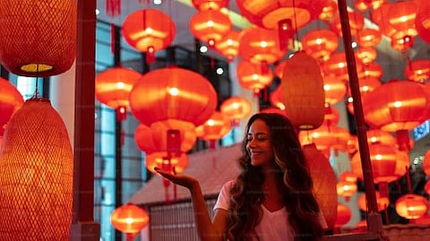 On the day of festivity, tourists and locals gather in large numbers to witness a parade of luminous paper lanterns or Khom Loi floating skyward in an ethereal procession. (Unsplash)