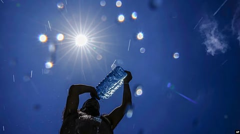 A man pours cold water onto his head to cool off on a hot day in the Mediterranean Sea in Beirut, Lebanon, July 16, 2023. As temperatures and humidity soar outside, what's happening inside the human body can become a life-or-death battle. VOA