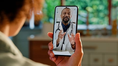 Person having an online video call with a doctor on a smartphone.