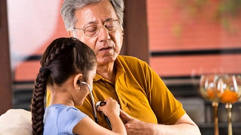 Girl showing something to an elderly man.