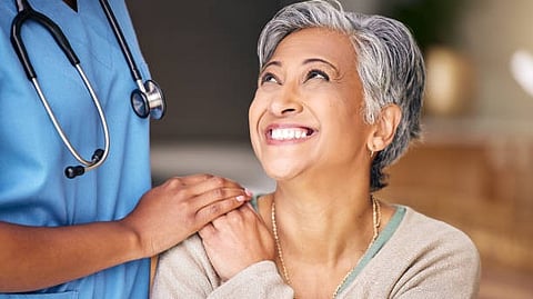 A woman gently touches another woman's face, conveying a moment of intimacy and connection between them.