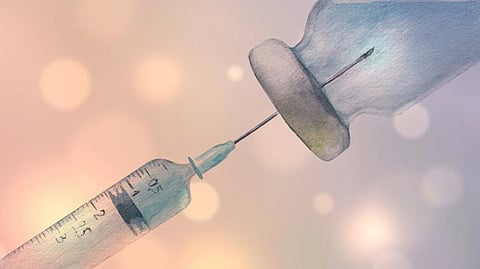 A drawing of a syringe placed on a tablet, illustrating a medical or health-related theme.