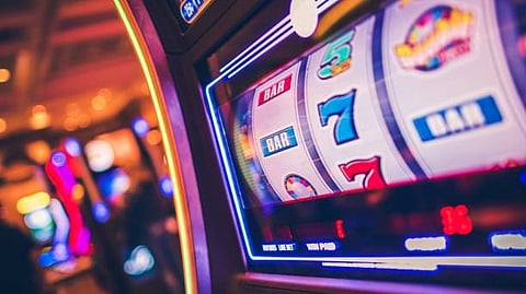 A casino gaming machine is visible on a computer screen, illustrating its interactive elements and bright visuals.