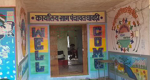 The image shows a colorful wall mural with bold letters and artwork, featuring vibrant designs and text in different languages.