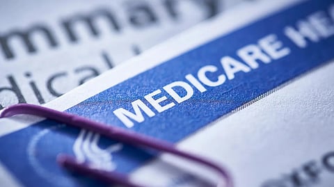 Close view of a blue Medicare health insurance card with partial text visible.