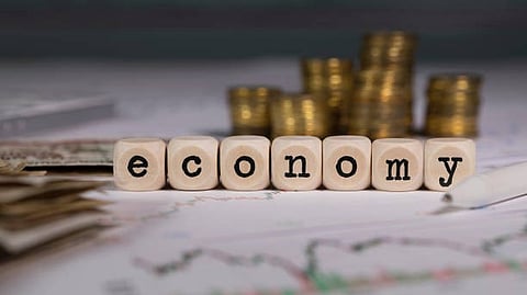 Wooden letter box show spelling th eword "economy"