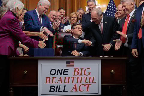 Speaker of the House Mike Johnson is congratulated by fellow Republicans after signing the GOP megabill on July 3. (Chip Somodevilla/Getty Images)