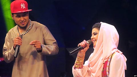 Afghan singer Zulala Hashemi (r) performs alongside competitor Sayed Jamal Mubarez (l) during the television music competition Afghan Star.
