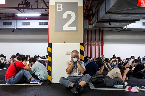 People take shelter during an air raid drill coinciding with the Han Kuang military exercises in Taipei on July 17, 2025. (I-hwa Cheng/AFP)