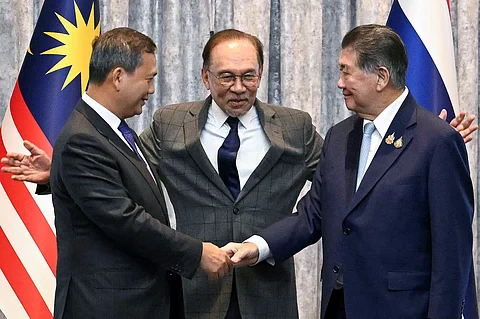 Malaysia's Prime Minister Anwar Ibrahim stands with Cambodia's Prime Minister Hun Manet and Thailand's acting Prime Minister Phumtham Wechayachai as they shake hands at a press conference regarding a ceasefire for Thailand–Cambodia border conflict, in Putrajaya, Malaysia, July 28, 2025. (Mohd Rasfan/via Reuters)