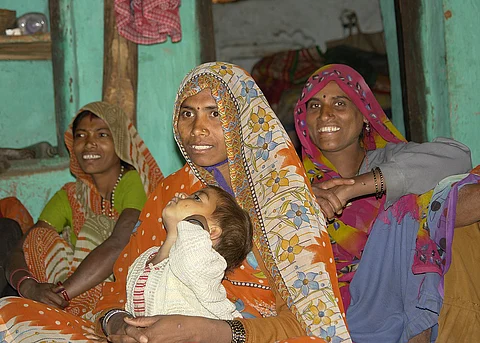 in the image a mother is shown with her daughter and lack of infrastructure is shown