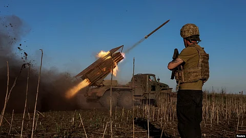 Ukrainian soldiers fire a multiple-rocket launcher toward Russian troops near Pokrovsk.