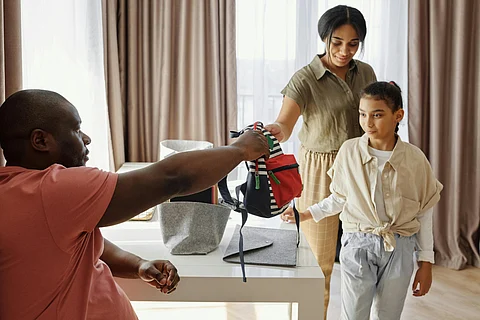 Image of parents getting their kids ready