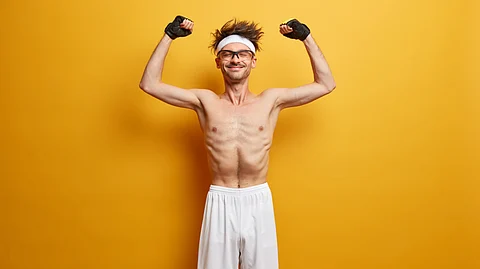 A skinny guy posing physique with yellow background.
