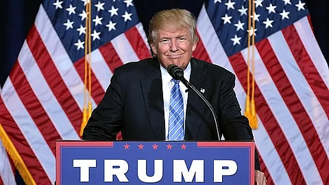 President Donald trump standing on podium.