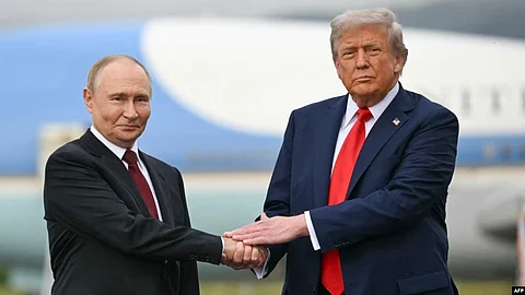 US President Donald Trump (right) greets Russian President Vladimir Putin on the tarmac at Joint Base Elmendorf-Richardson in Anchorage, Alaska, on August 15.
