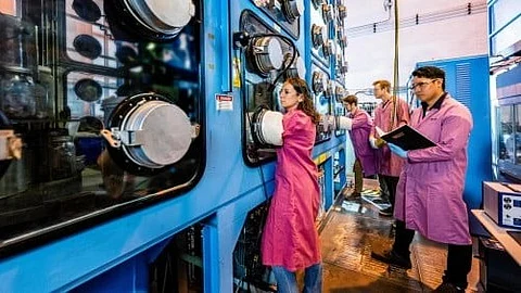 Argonne’s Krista Hawthorne, left, and colleagues work in Argonne’s pyroprocessing lab.