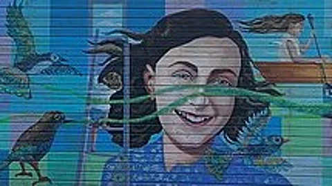 Painting of Anne frank on wall.
