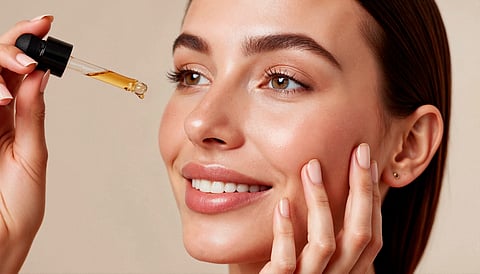 Woman applying retinol on her face.