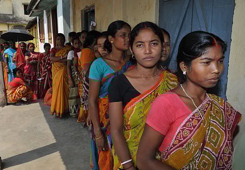 Women voters in a queue to cast their votes, at a polling booth in West Bengal.