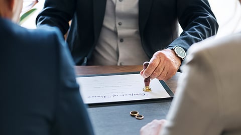 Couple going through divorce papers with a lawyer.