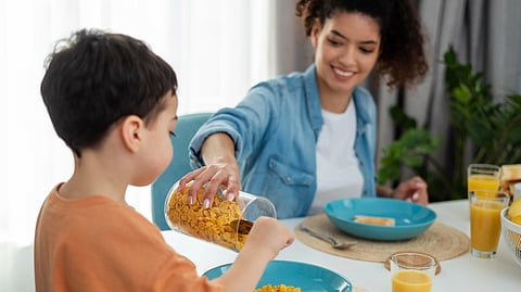 Mother and child eating together.