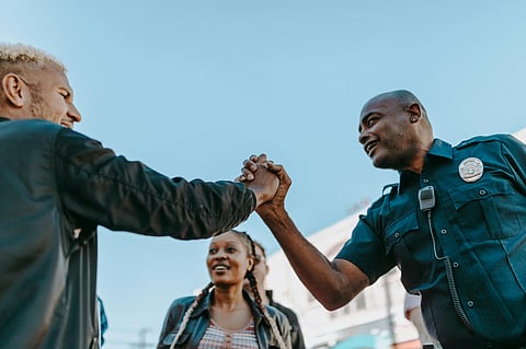 Black and white man shaking hand.