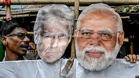 Activists carry an effigy of US President Donald Trump and Indian Prime Minister Narendra Modi in Kolkata as they protest against US tariffs levied on Indian exports in August.
