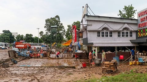 Jammu: Workers clean mud and debris from their shops after floodwaters entered due to flash floods in the Chakki River in Jammu on Wednesday, August 27, 2025.