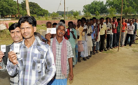 Voters standing in a queue to cast their votes, at a polling booth in Bihar.