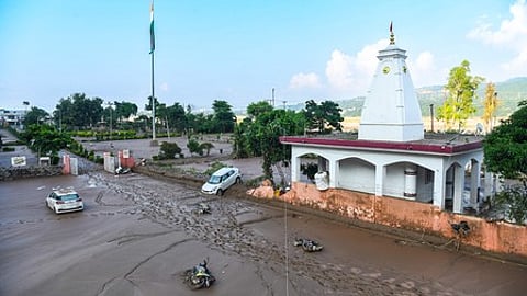 Jammu: Vehicles lie stranded in mud near a temple complex following flash floods, in Jammu on Thursday, August 28, 2025.