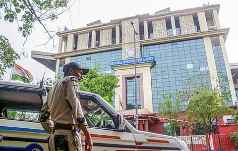 New Delhi: Delhi Police and Central Industrial Security Force (CISF) personnel stand guard outside the National Investigation Agency (NIA) headquarters in New Delhi on Friday, April 11, 2025.