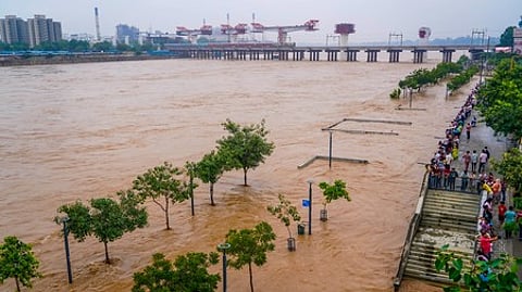 Ahmedabad: People watch flood water on the walkway of Sabarmati Riverfront, in Ahmedabad, Sunday, September 7, 2025.