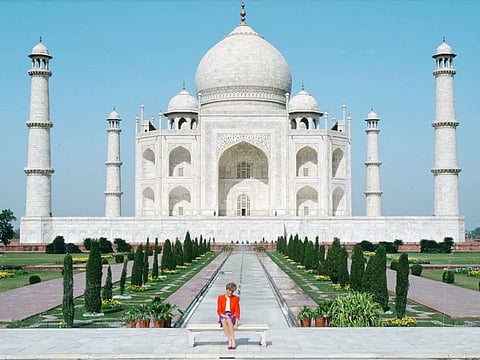 Princess Diana's Visit to the Taj Mahal in 1992. She sits alone on a bench in front of the monument.