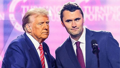 Charlie Kirk shaking hands with Donald Trump at a Turning Point event